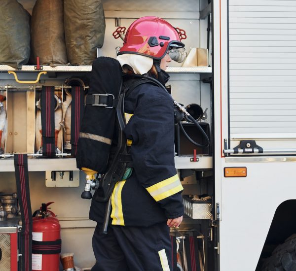 female firefighter standing near truck
