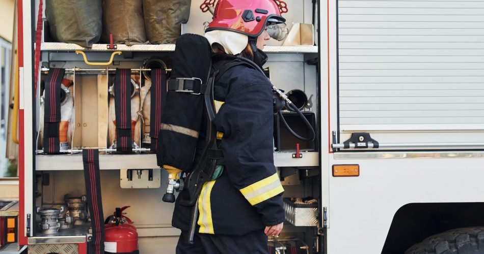 female firefighter standing near truck